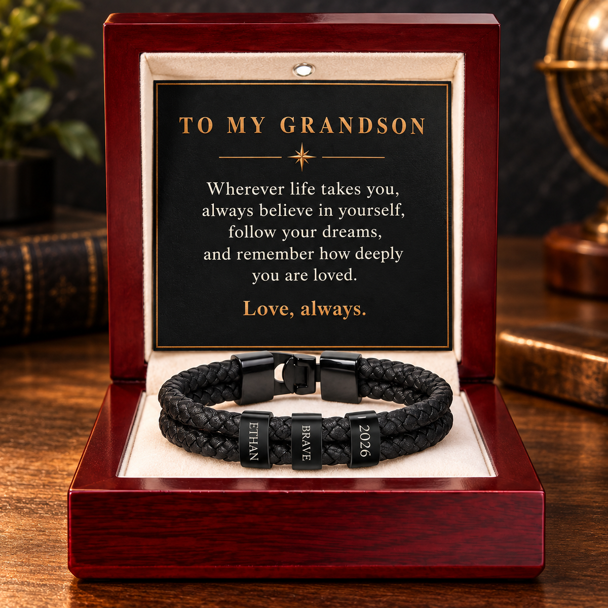 Black-finish personalized bracelet with three engraved rings in a luxury mahogany gift box for a grandson.
